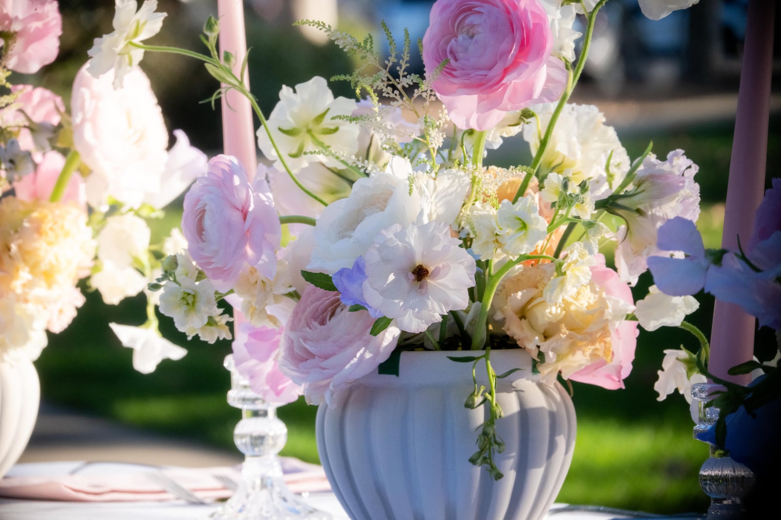 Lavender, blush, and ivory centerpiece in a white fluted vase