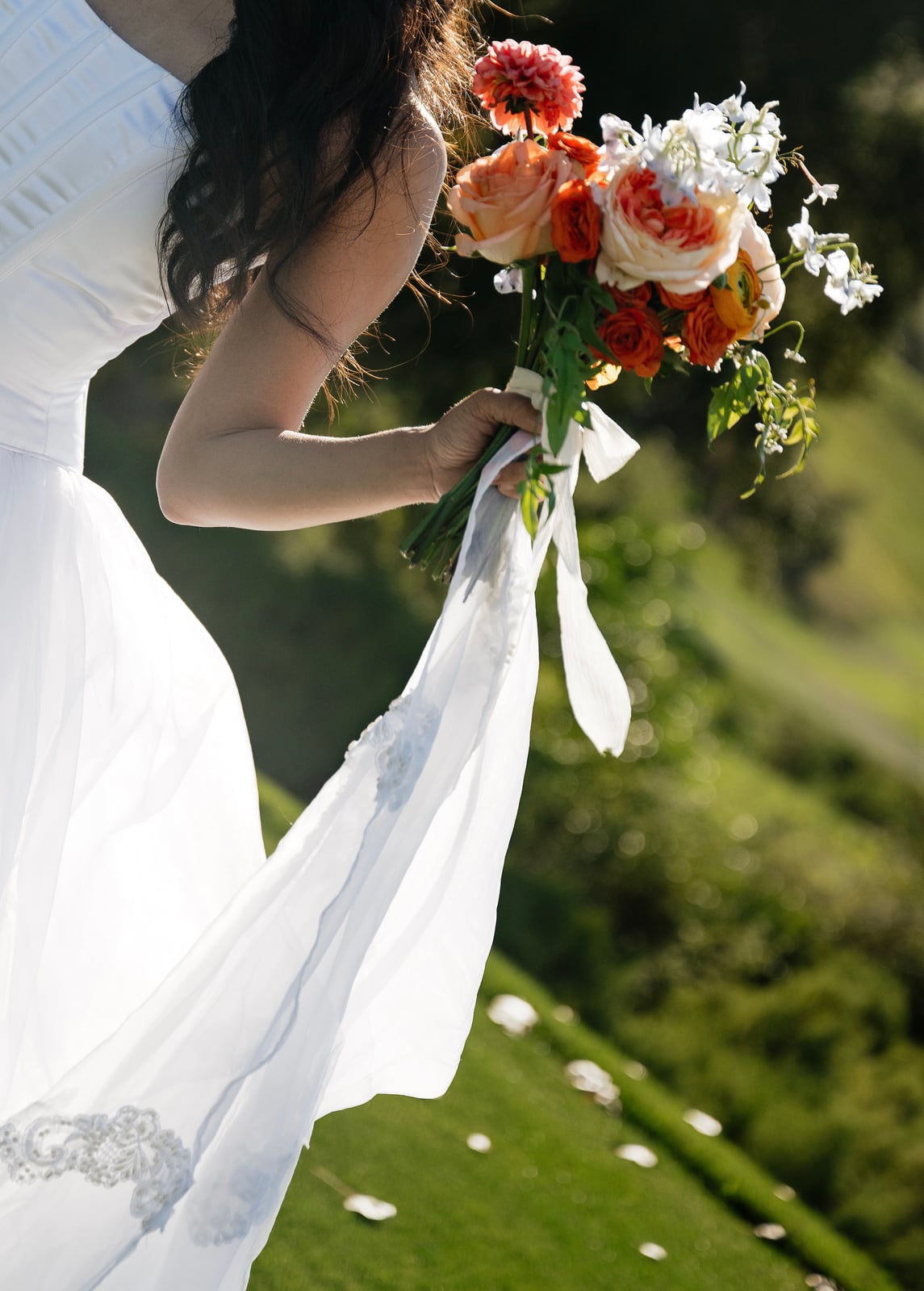Bride carrying a warm-toned bouquet