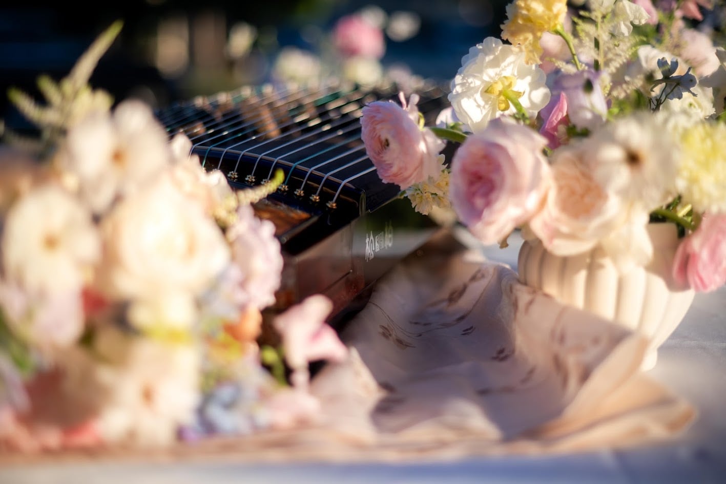 Soft pink and ivory flowers arranged on a reception table