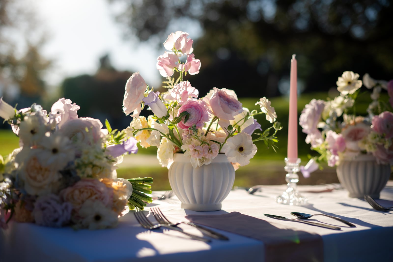 Pastel floral centerpiece on an outdoor reception table