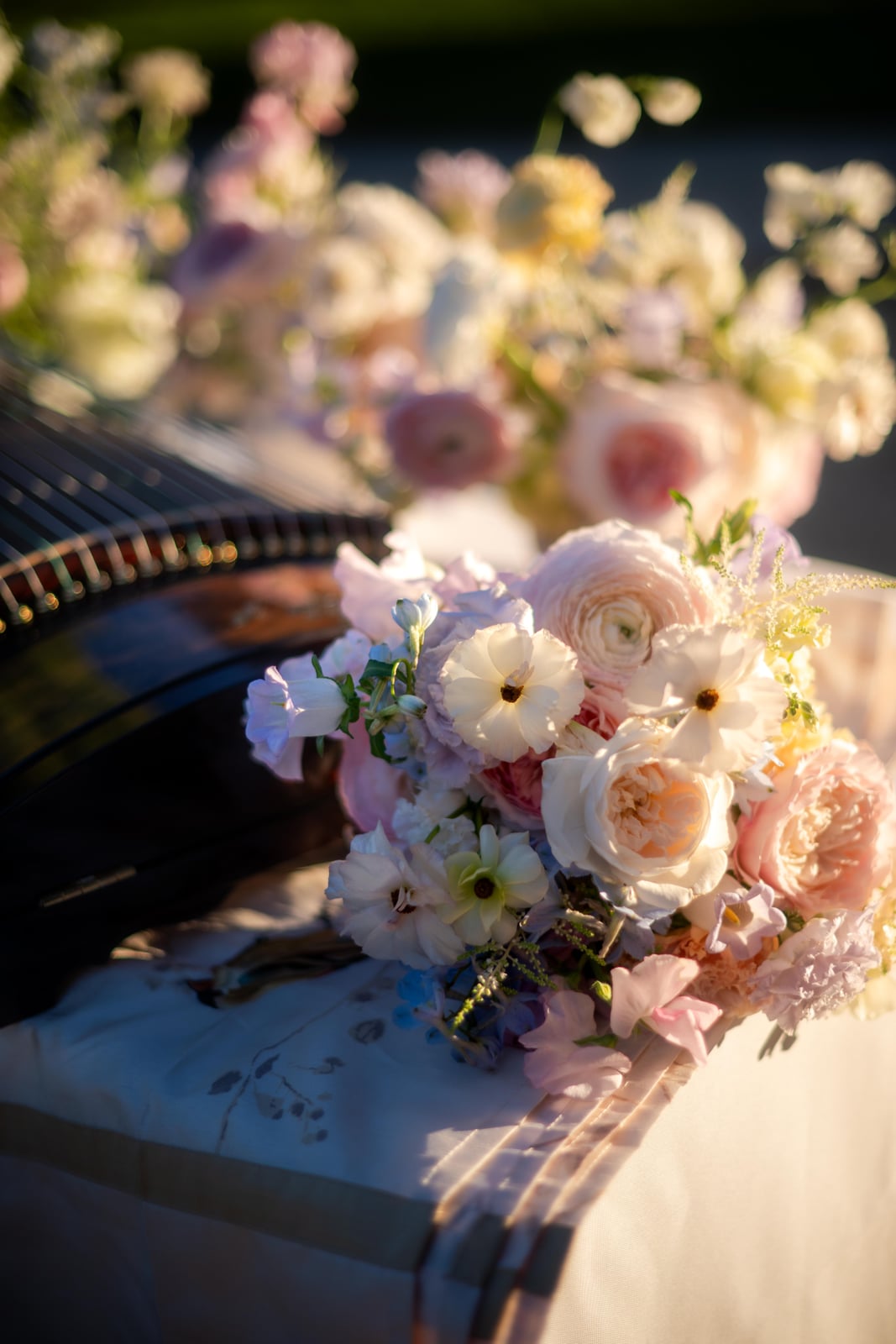 Pastel bridal bouquet held beneath a sheer veil