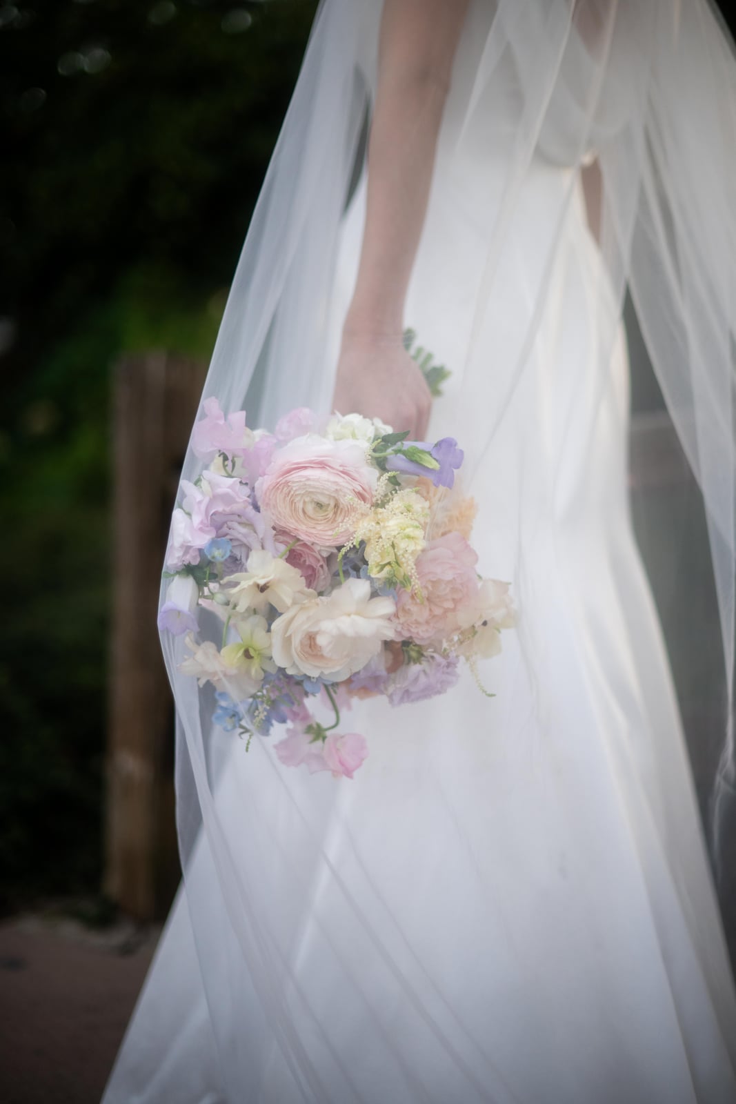 Soft pastel centerpiece on a sunlit reception table